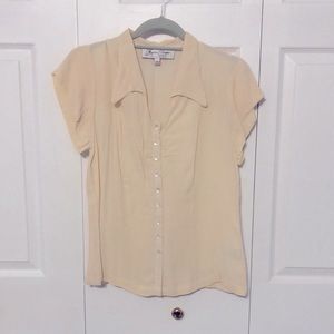 Woman’s cream colored blouse.